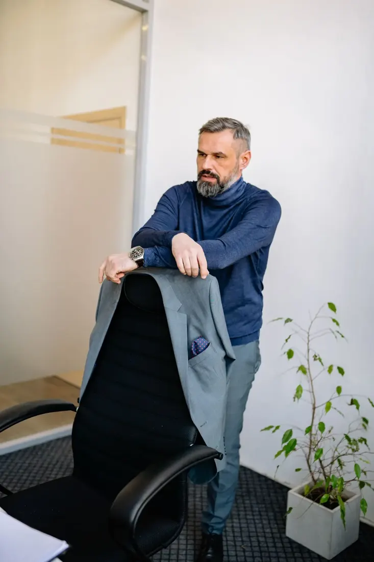 College director standing in his office