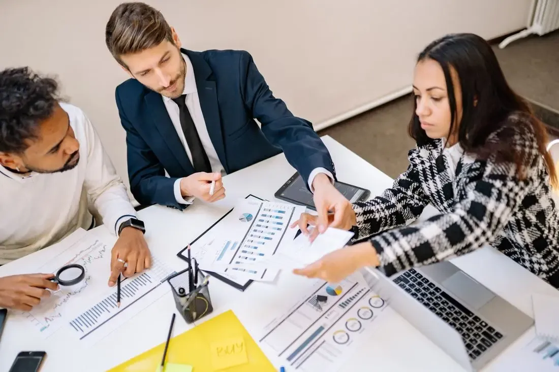 A hiring team reviewing candidate scorecards together